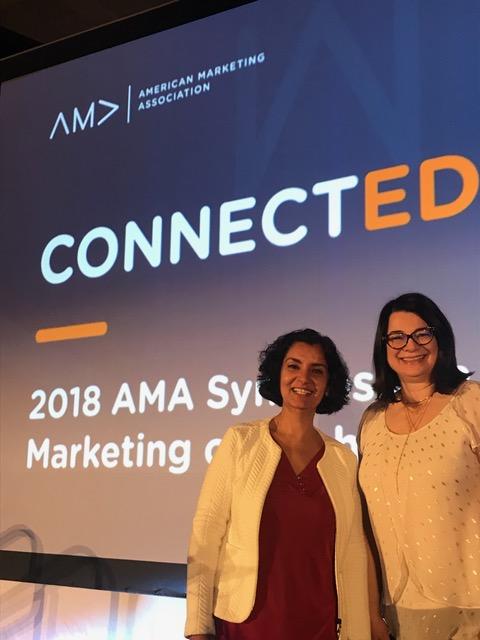 Anju Visen-Singh, senior director of marketing and digital experience, and Mona Csada, associate director of marketing, accept the AMA Higher Education Marketing Team of the Year award on behalf of the University of Calgary.