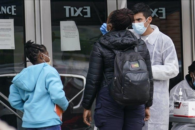 A medical professional administers a COVID-19 test in front of the Kew Gardens Cinemas movie theatre in the Queens borough of New York City on Oct. 5, 2020