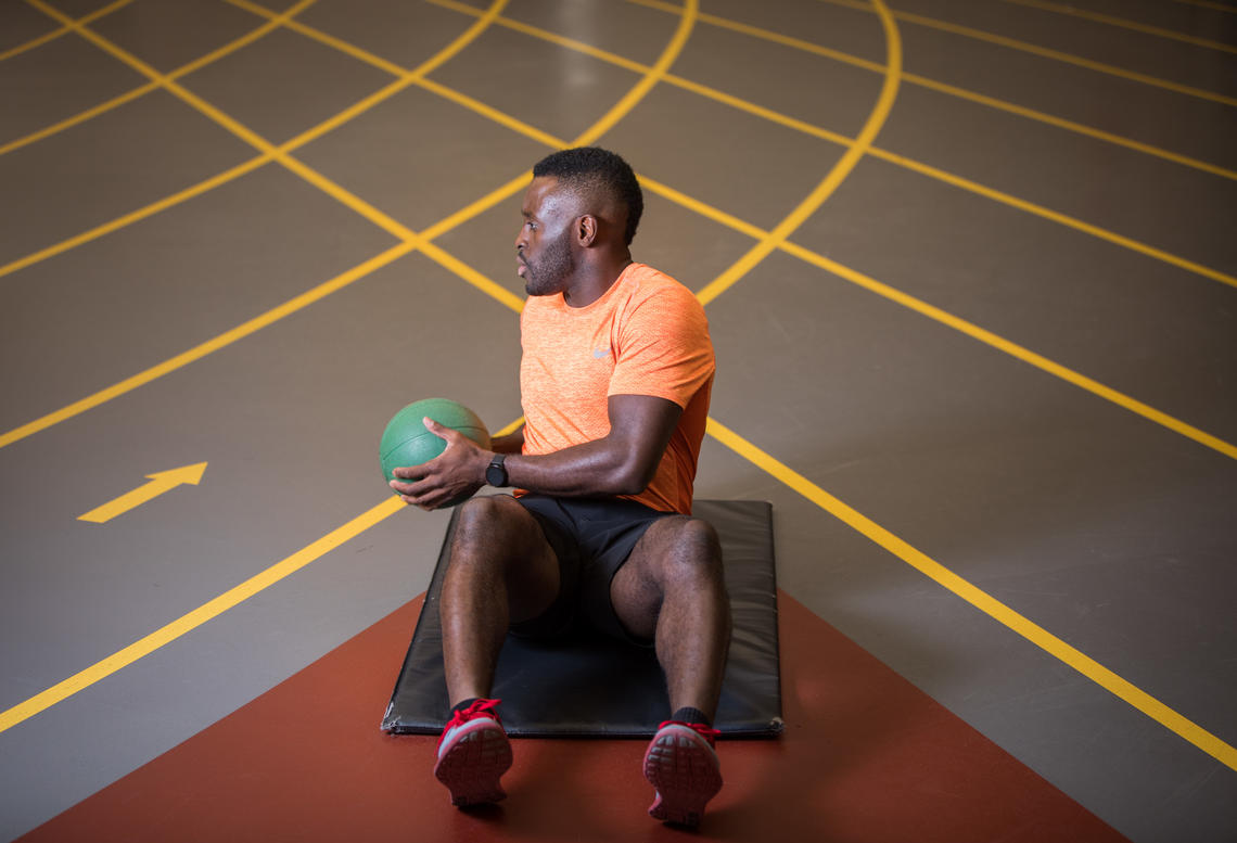 Sam Effah Demonstrating medicine ball twists