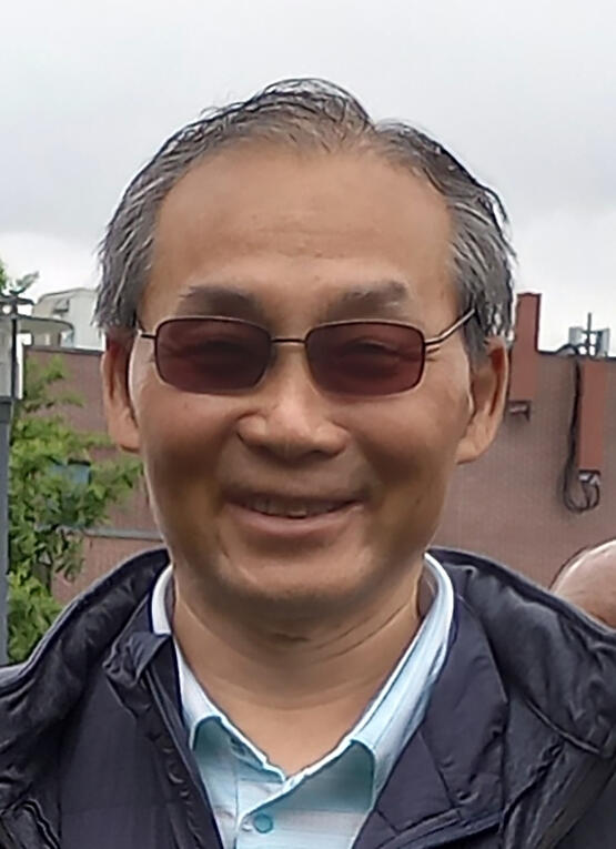 portrait photo of a man wearing sunglasses, standing outdoors