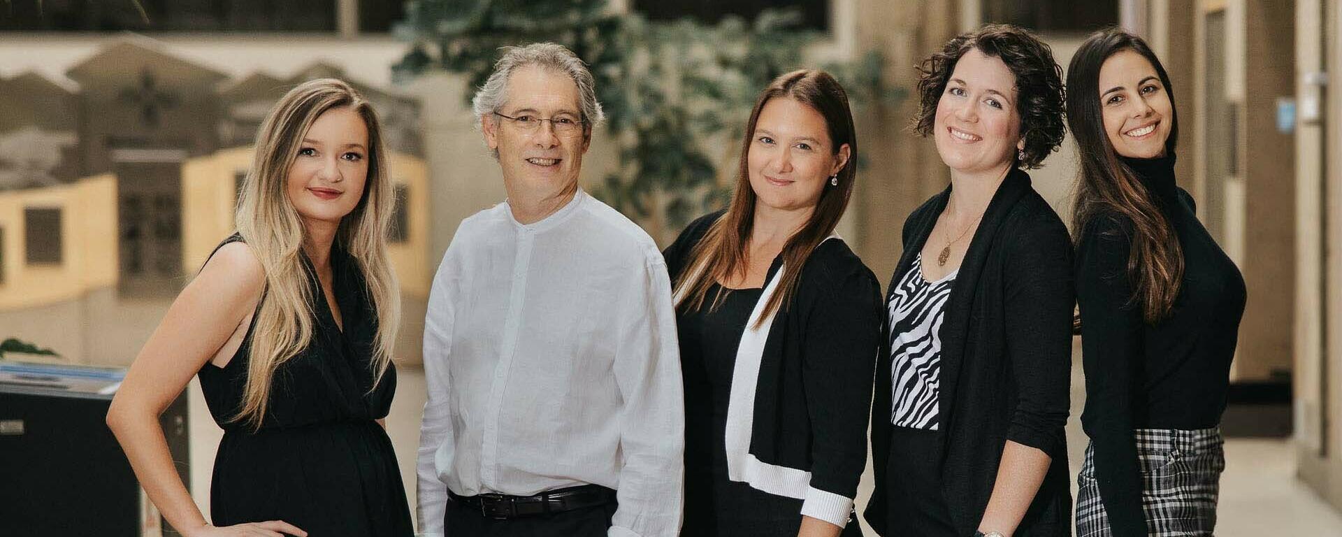 Five members of the ACT-PD team stand side-by-side, posing as a group.