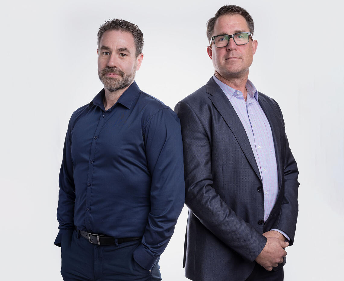 Dr. Matthew Hill and Trevor Johnson standing beside each other.