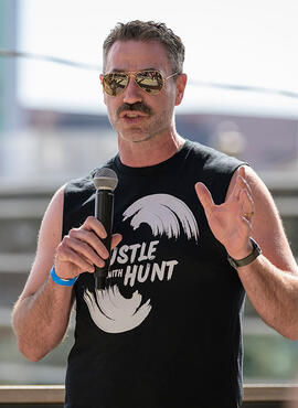 Dr. Matthew Hill speaks into a microphone.