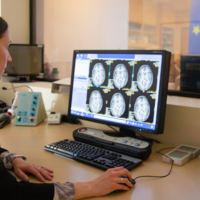 woman with MRI on screen