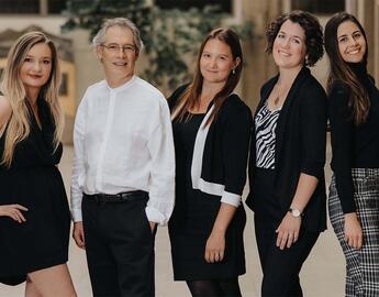 Five members of the ACT-PD team stand side-by-side, posing as a group.